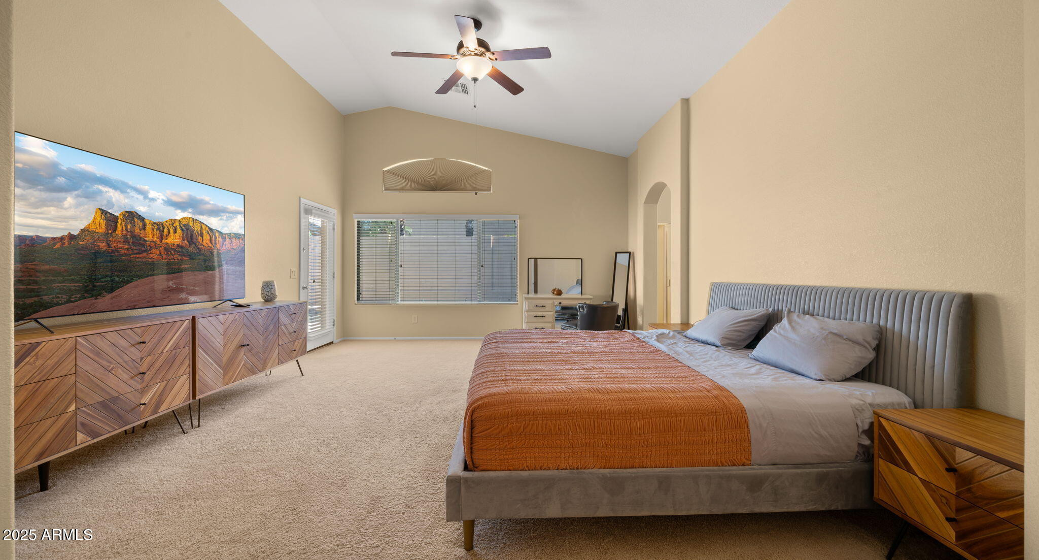 2215 West Peak View Road Phoenix, AZ 85085 - Photo 29 of 51 a spacious bedroom with a bed and a flat screen tv
