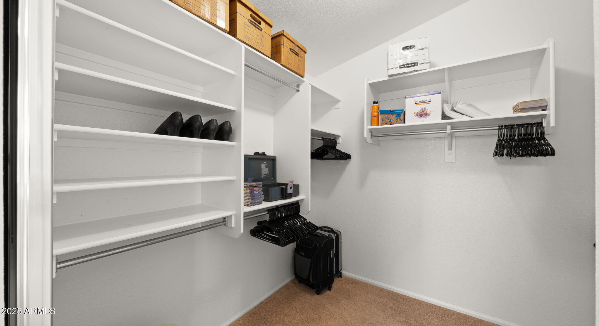 2215 West Peak View Road Phoenix, AZ 85085 - Photo 34 of 51 a view of walk in closet with clothes and shoes