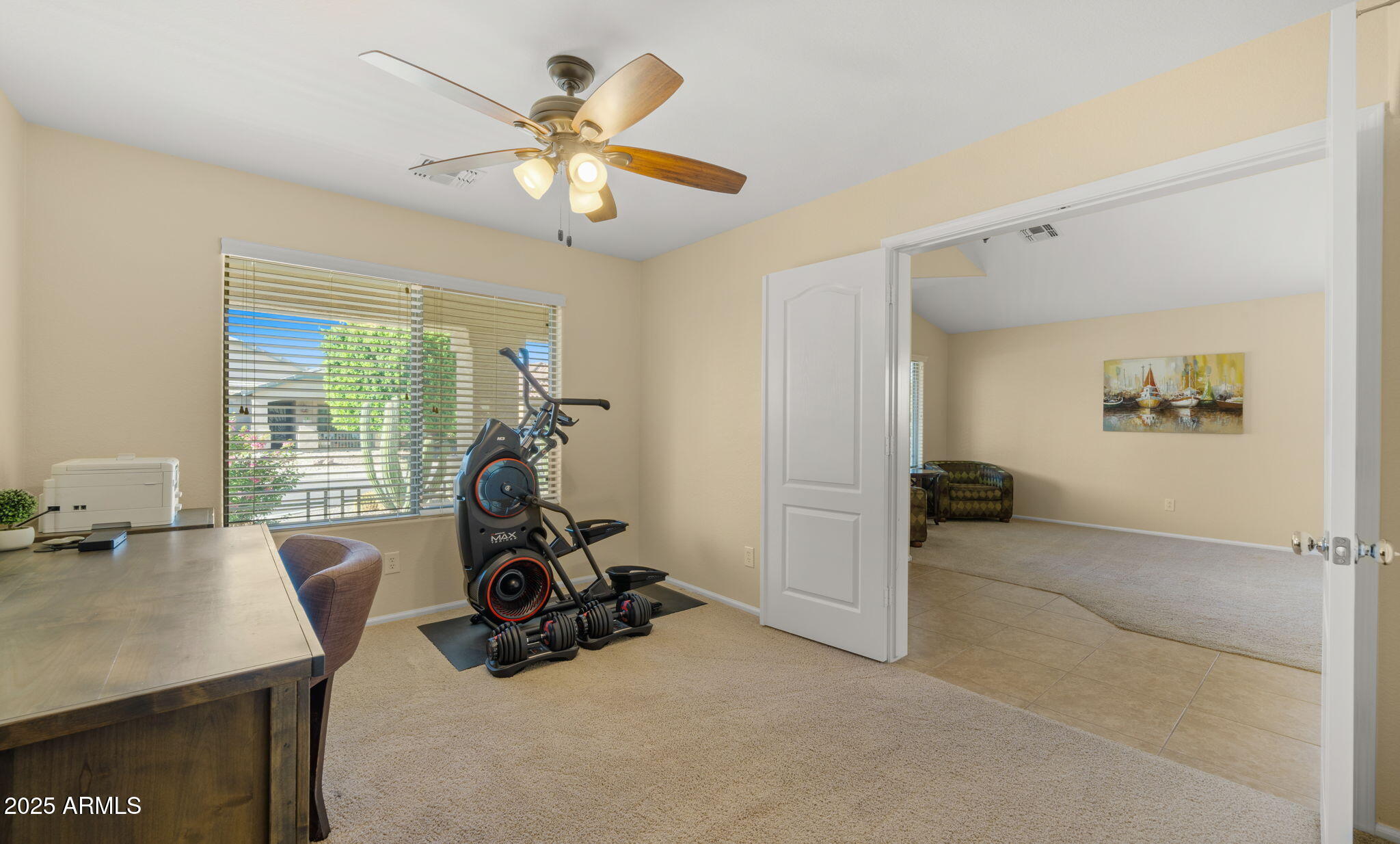 2215 West Peak View Road Phoenix, AZ 85085 - Photo 9 of 51 a room with gym equipment and a view of living room