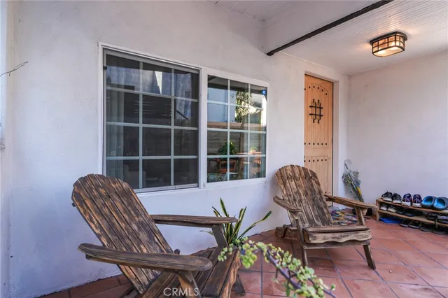 a bedroom with a bed and a lamp on dresser