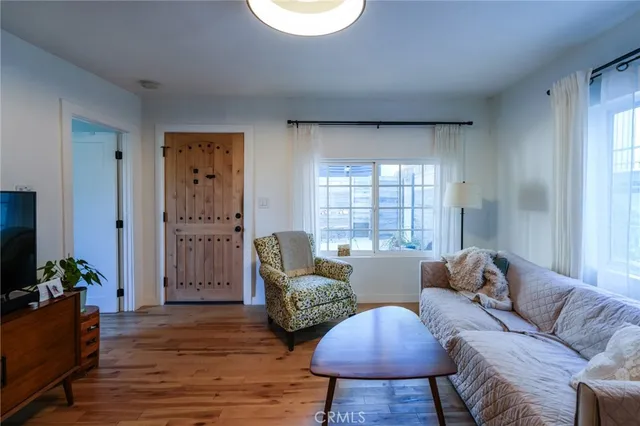 a view of a house with a yard and potted plants