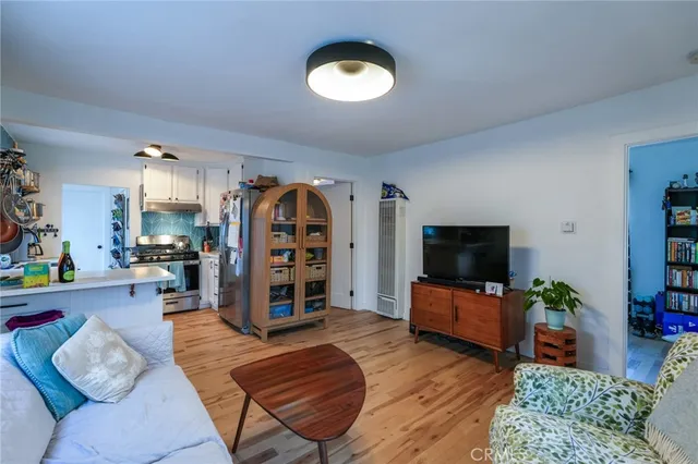 a view of hallway with window and wooden floor