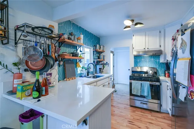 a bathroom with a granite countertop bathtub shower and toilet