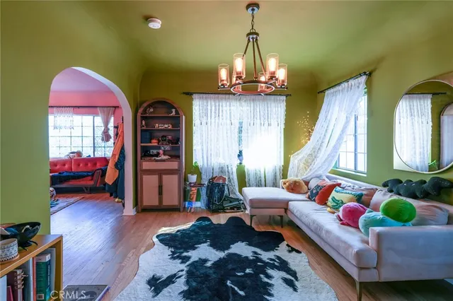 a living room with furniture and a chandelier