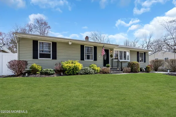 a front view of house with yard and green space