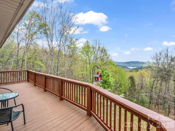 a view of a balcony with wooden fence and floor