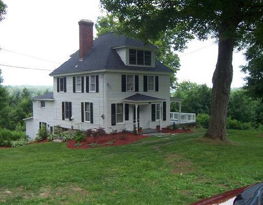 a front view of house with yard and outdoor seating