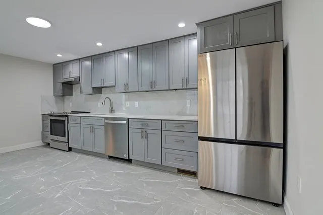 a bathroom with a sink toilet vanity and shower