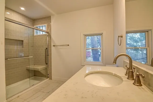 a bathroom with a glass shower door