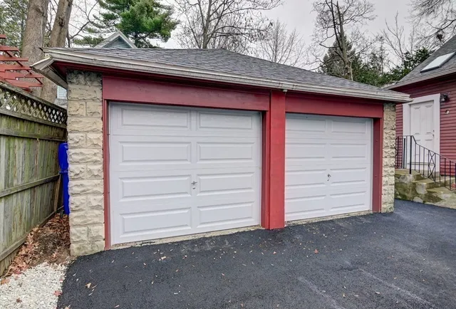 an aerial view of residential houses and car parked on street