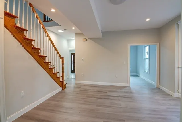 a view of an entryway with wooden floor
