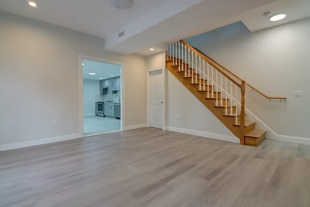 a view of a kitchen with a sink and dishwasher a refrigerator with wooden floor
