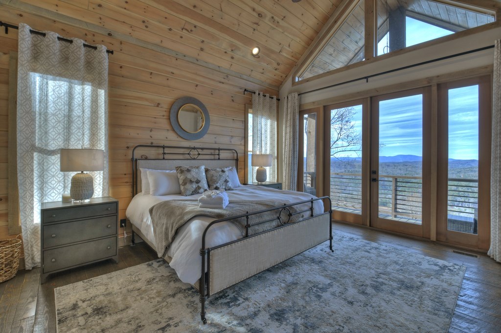 472 Overlook Drive Blue Ridge, GA 30513 - Photo 35 of 70 a bed sitting in a spacious bedroom next to a window