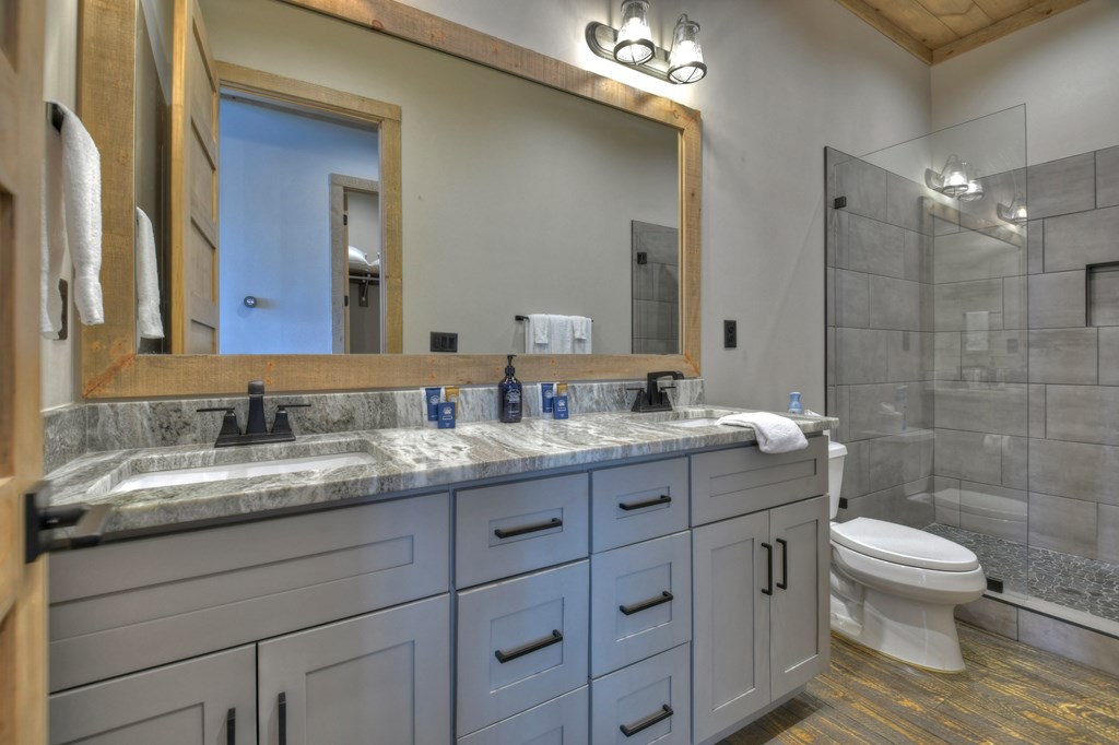 472 Overlook Drive Blue Ridge, GA 30513 - Photo 38 of 70 a bathroom with a granite countertop sink mirror and toilet