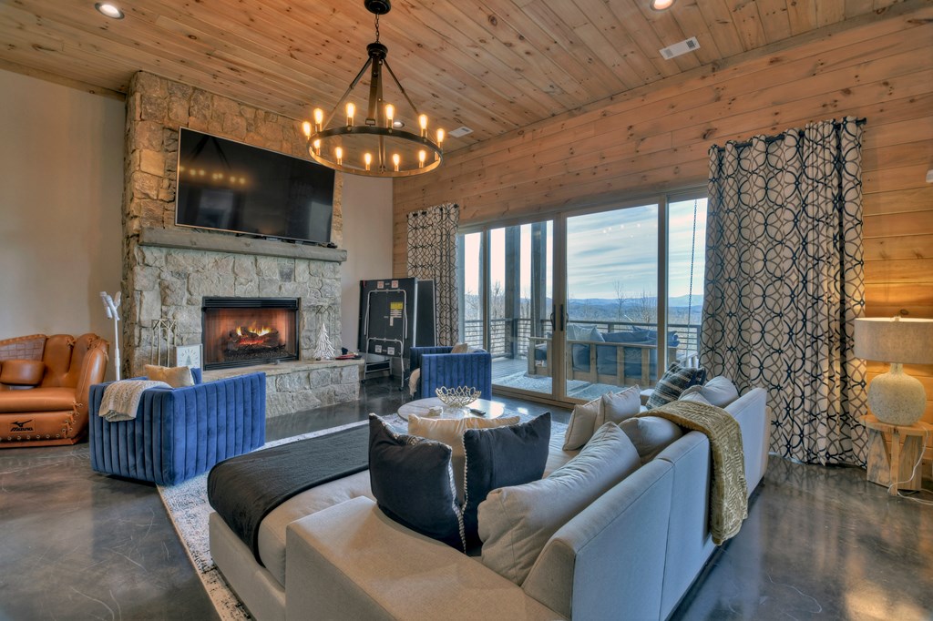 472 Overlook Drive Blue Ridge, GA 30513 - Photo 40 of 70 a living room with furniture a fireplace and a flat screen tv