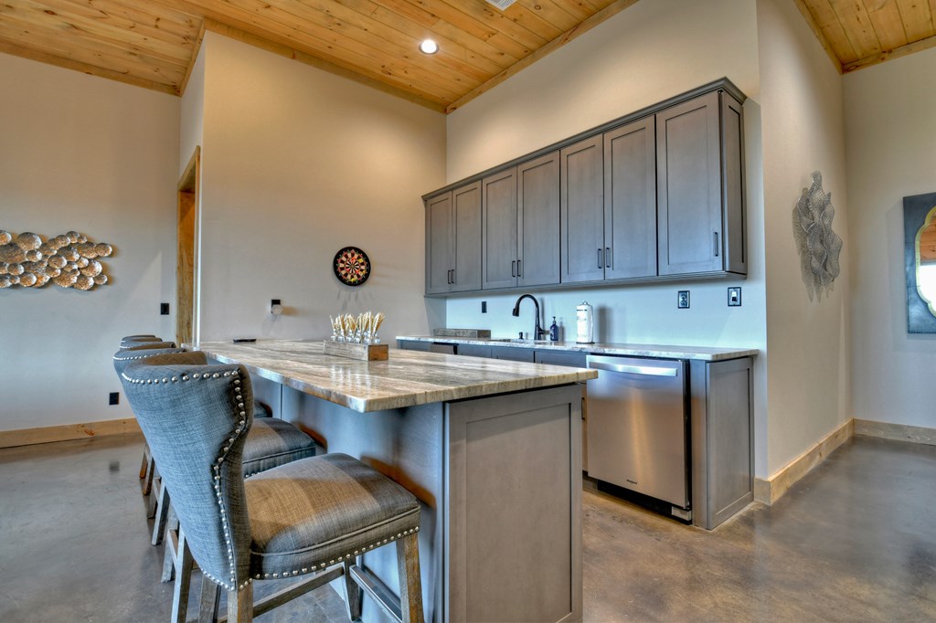 472 Overlook Drive Blue Ridge, GA 30513 - Photo 42 of 70 a kitchen with kitchen island a sink table and chairs