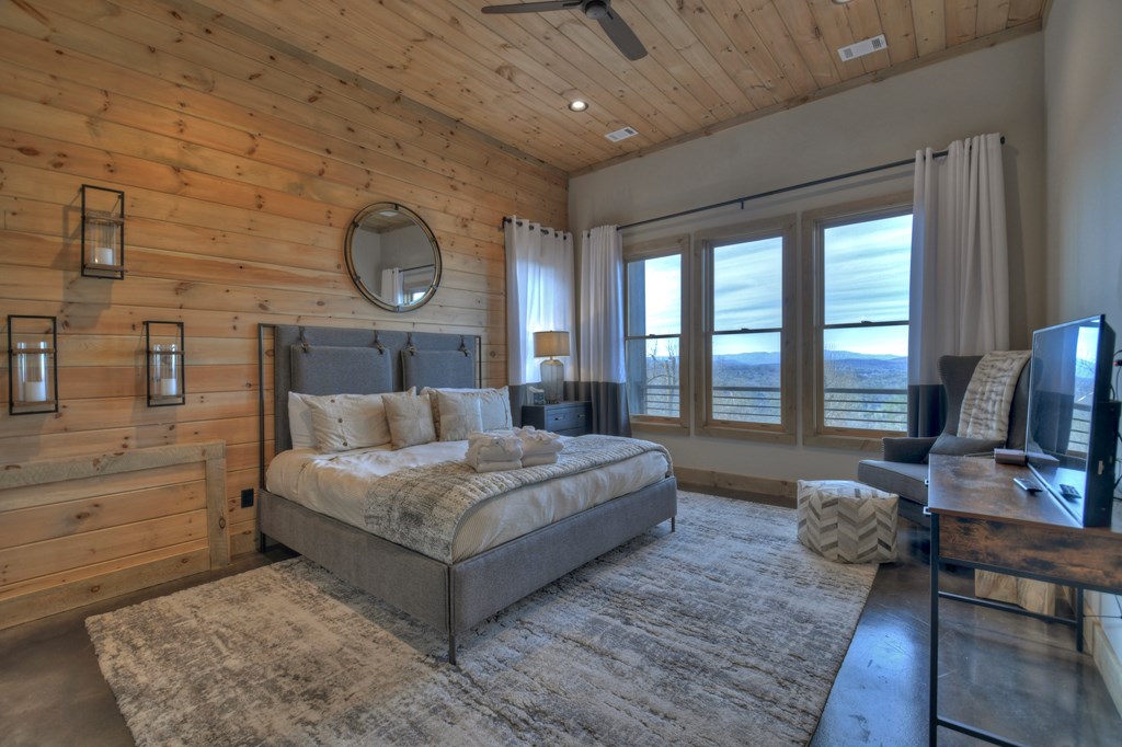 472 Overlook Drive Blue Ridge, GA 30513 - Photo 44 of 70 a bedroom with a bed a bookshelf and a large window