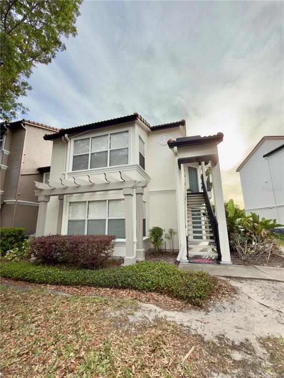 5152 Conroy Road, Unit 17 Orlando, FL 32811 - Photo 2 of 21 a front view of a house with garden