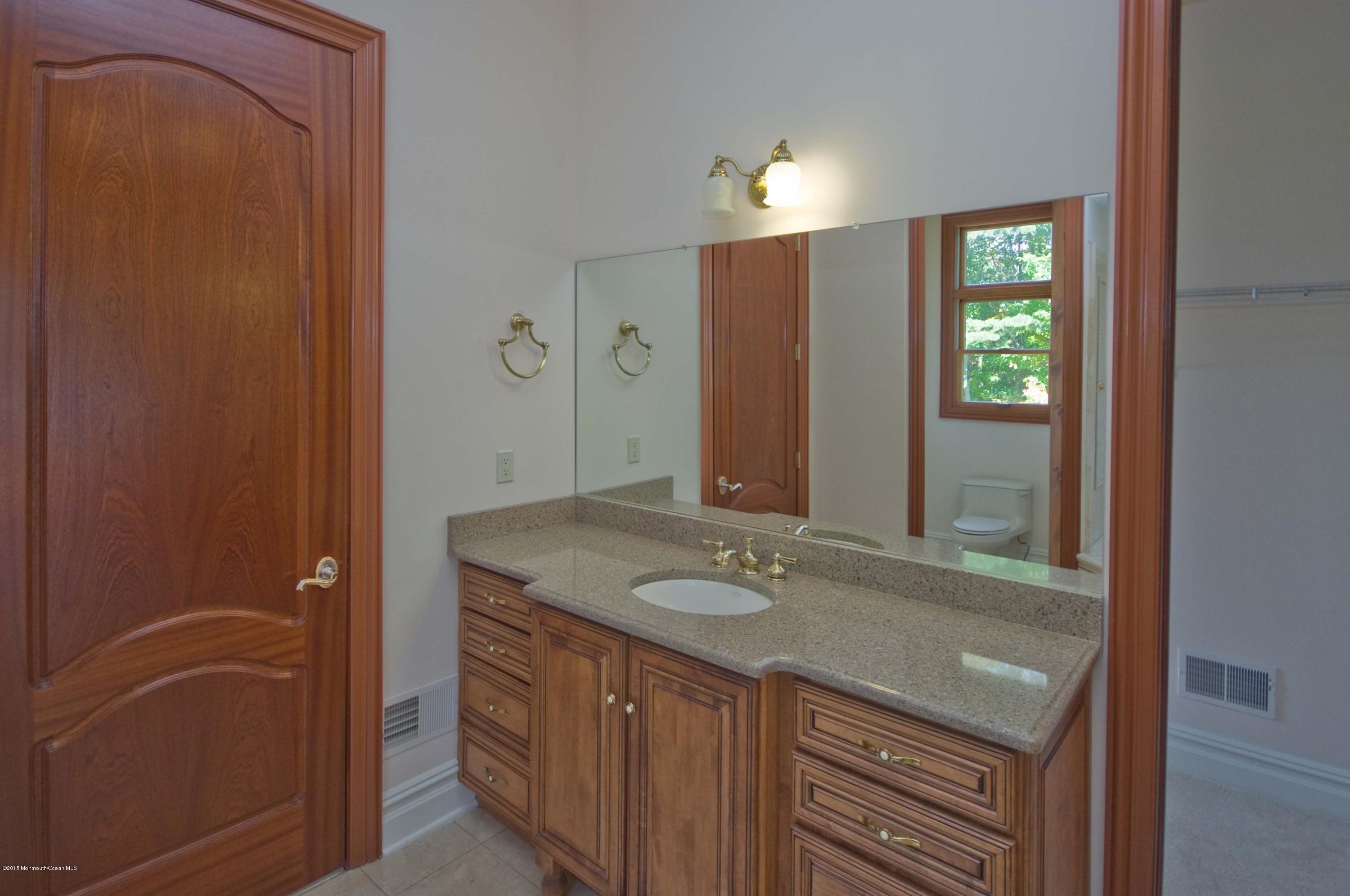 81 Potts Road Robbinsville, NJ 08691 - Photo 17 of 37 a bathroom with a granite countertop sink and a mirror