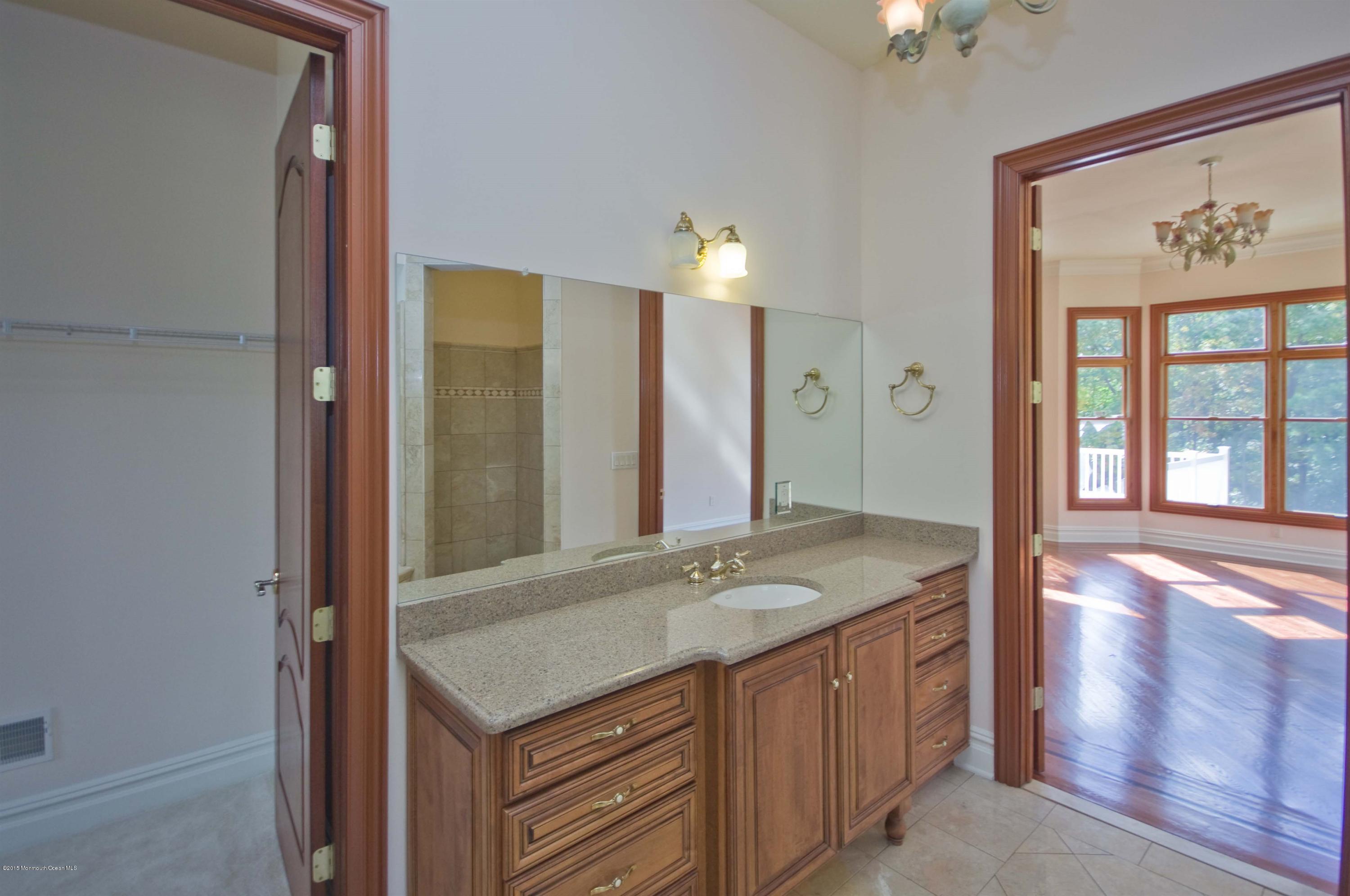81 Potts Road Robbinsville, NJ 08691 - Photo 18 of 37 a bathroom with a granite countertop sink and a mirror