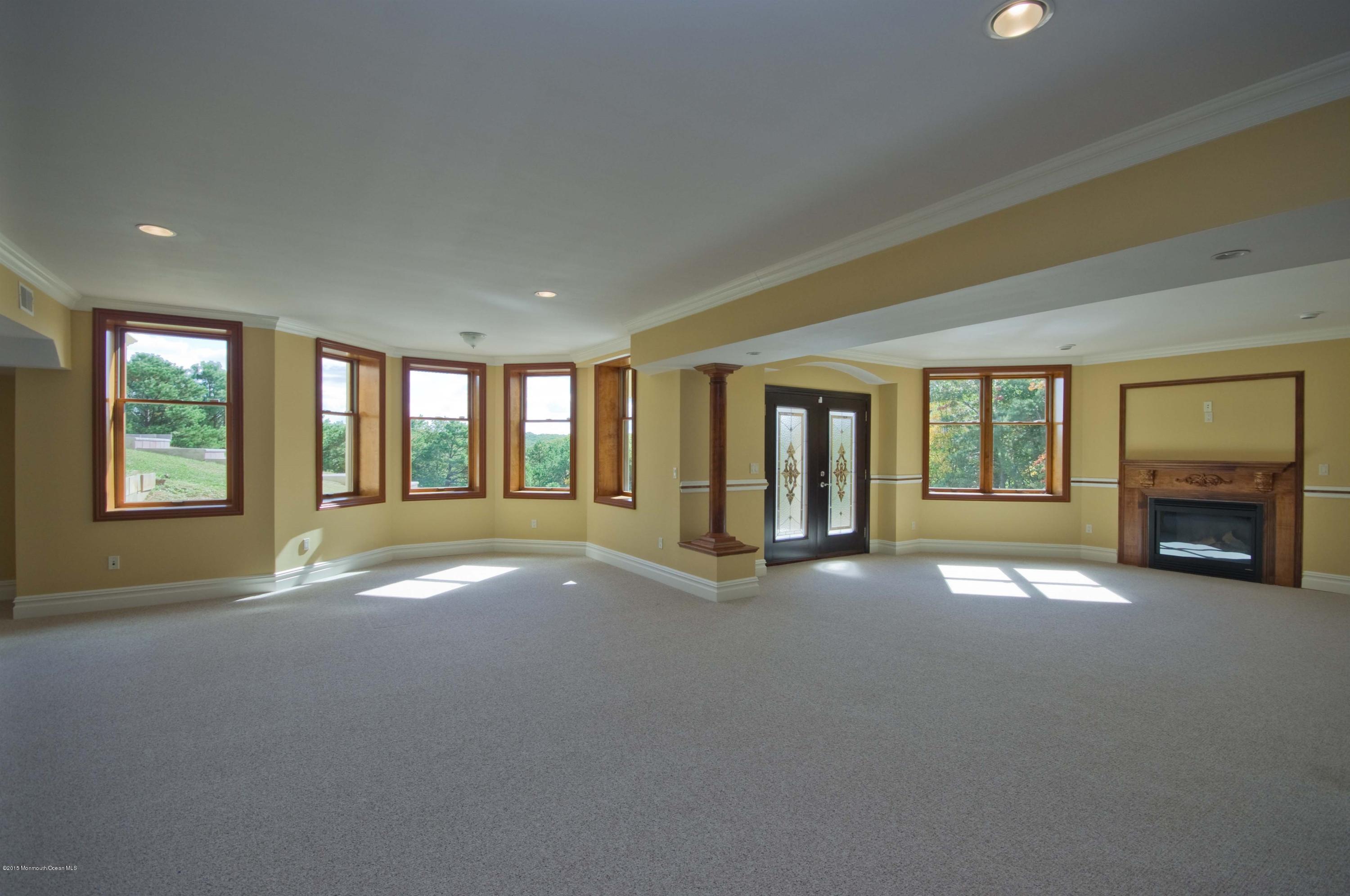 81 Potts Road Robbinsville, NJ 08691 - Photo 29 of 37 a view of an empty room with a fireplace and large windows