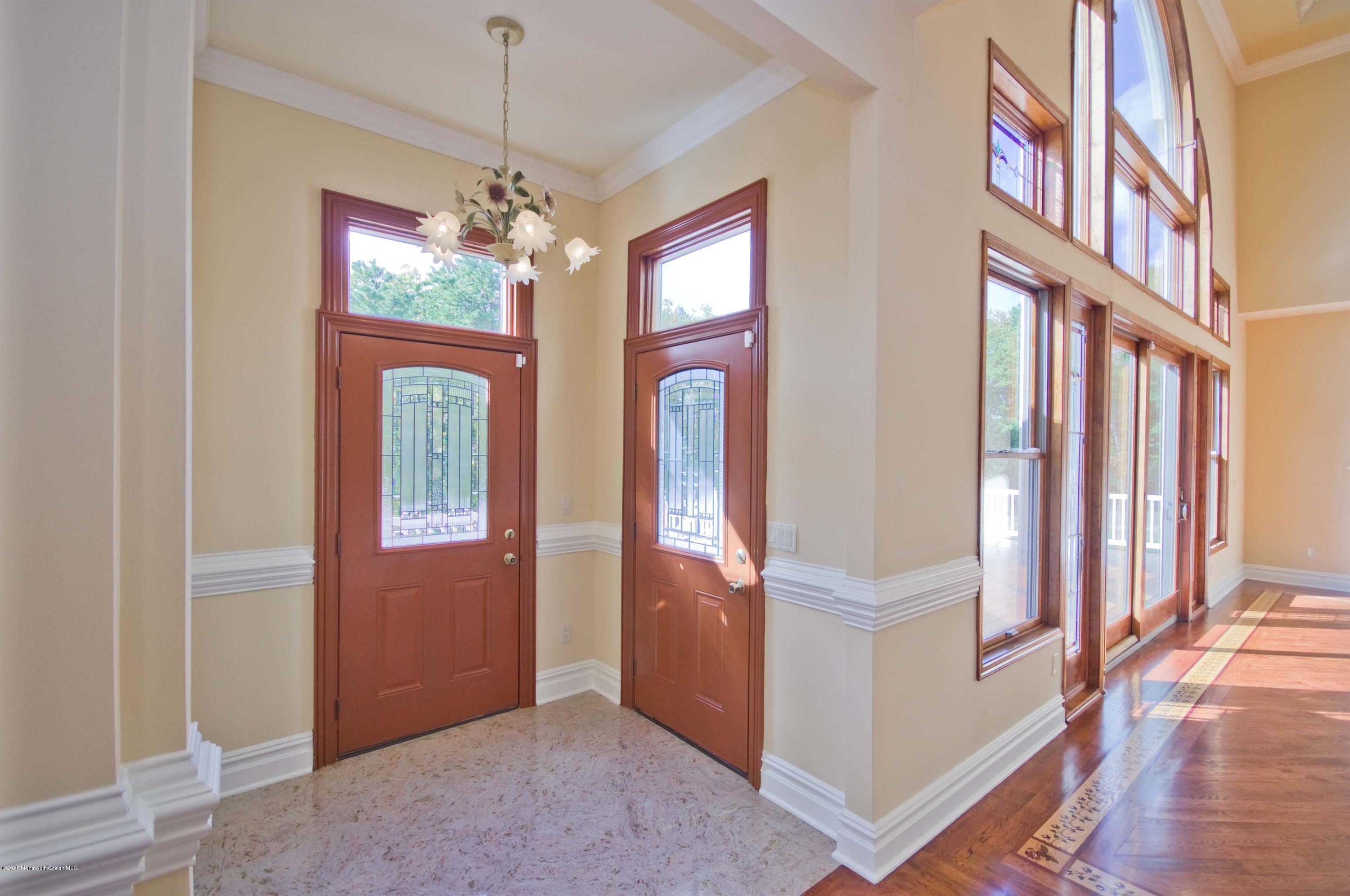 81 Potts Road Robbinsville, NJ 08691 - Photo 4 of 37 a view of an entryway with wooden floor and a chandelier