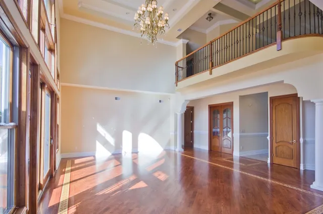 a view of an entryway with wooden floors door windows and a chandelier
