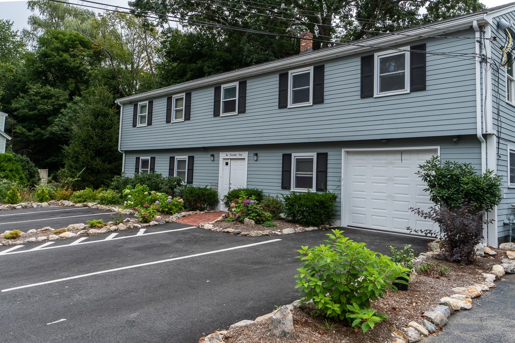 10 Riverbank Road, Unit 3 Maynard, MA 01754 - Photo 1 of 20 a front view of a house with yard and green space