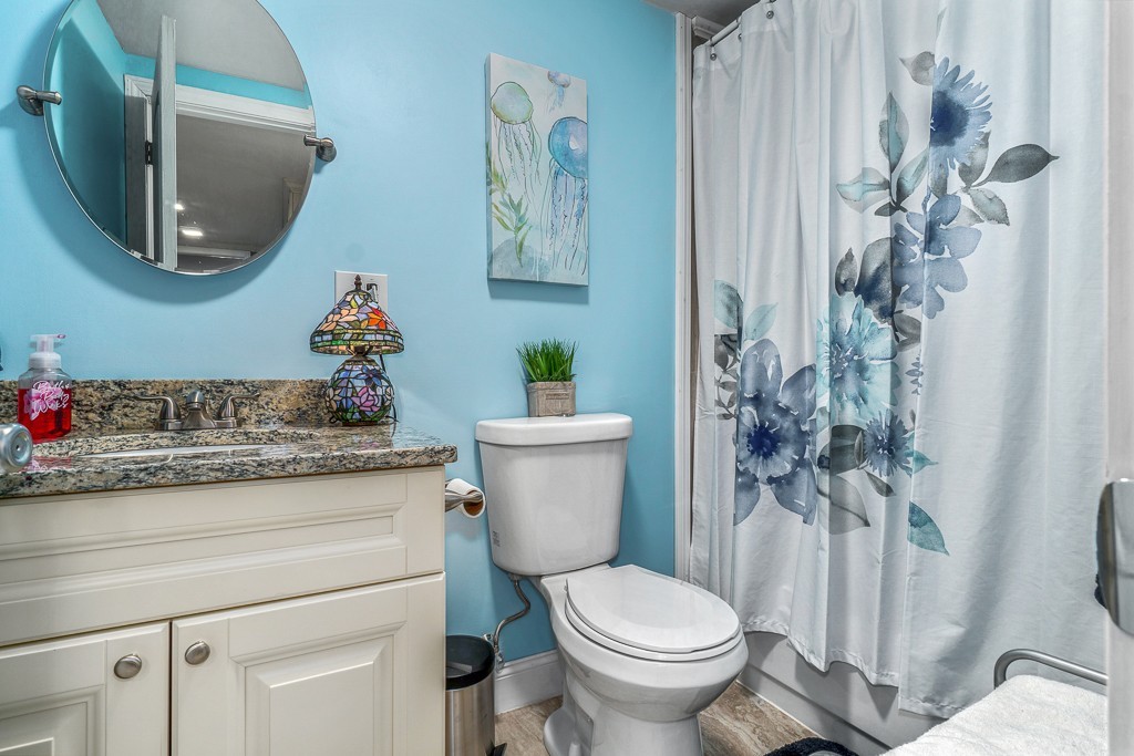 10 Riverbank Road, Unit 3 Maynard, MA 01754 - Photo 11 of 20 a bathroom with a toilet sink and mirror