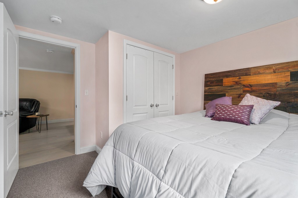 10 Riverbank Road, Unit 3 Maynard, MA 01754 - Photo 13 of 20 a bedroom with a bed and a view of bathroom
