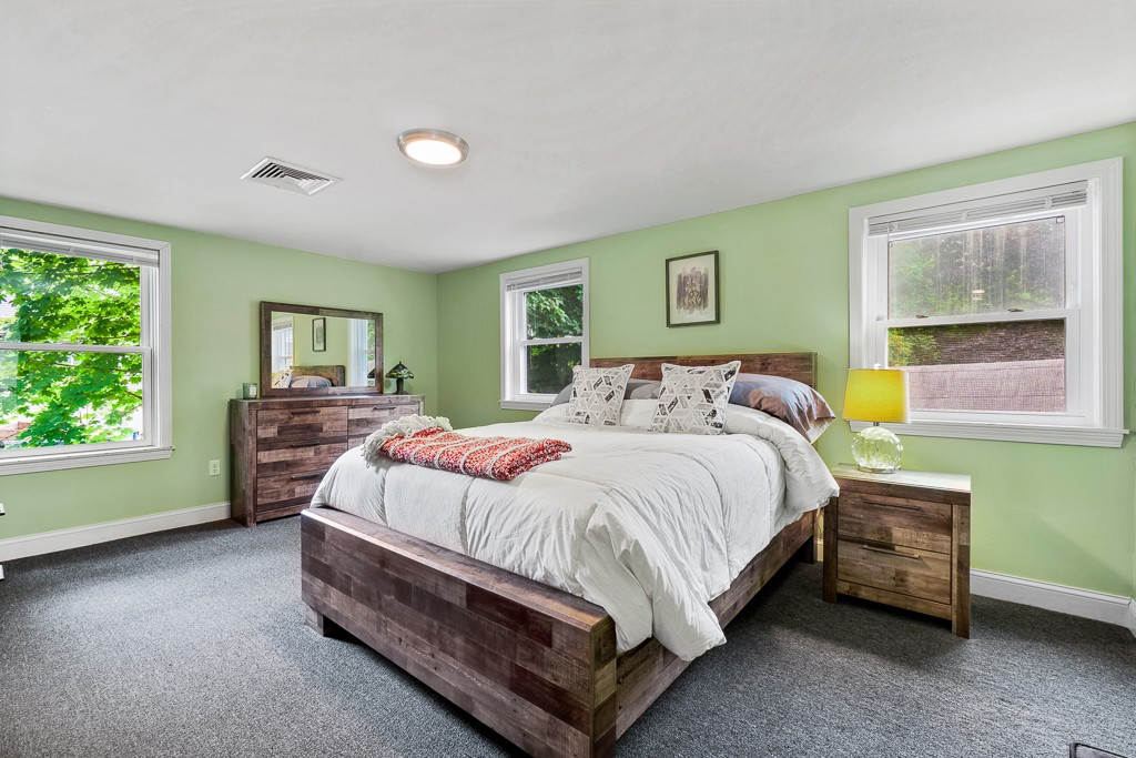 10 Riverbank Road, Unit 3 Maynard, MA 01754 - Photo 17 of 20 a bed sitting in a bedroom next to a window
