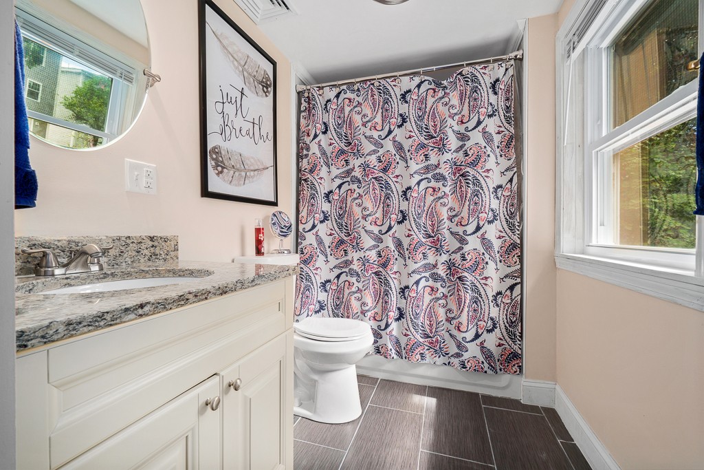 10 Riverbank Road, Unit 3 Maynard, MA 01754 - Photo 20 of 20 a bathroom with a granite countertop sink and a toilet