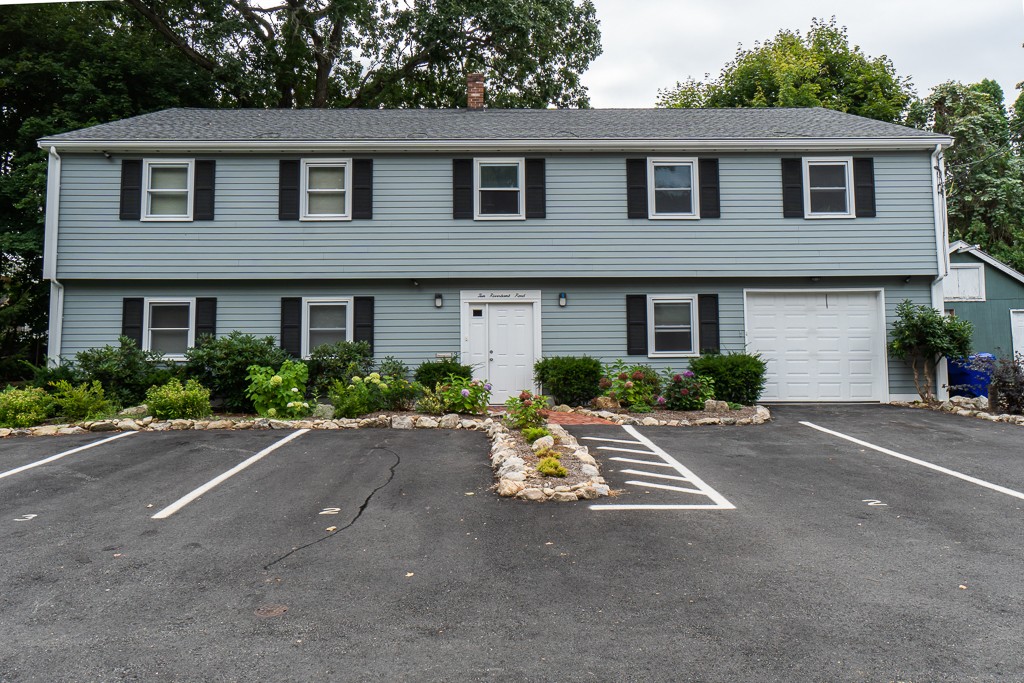 10 Riverbank Road, Unit 3 Maynard, MA 01754 - Photo 2 of 20 a front view of a house with a yard and garage