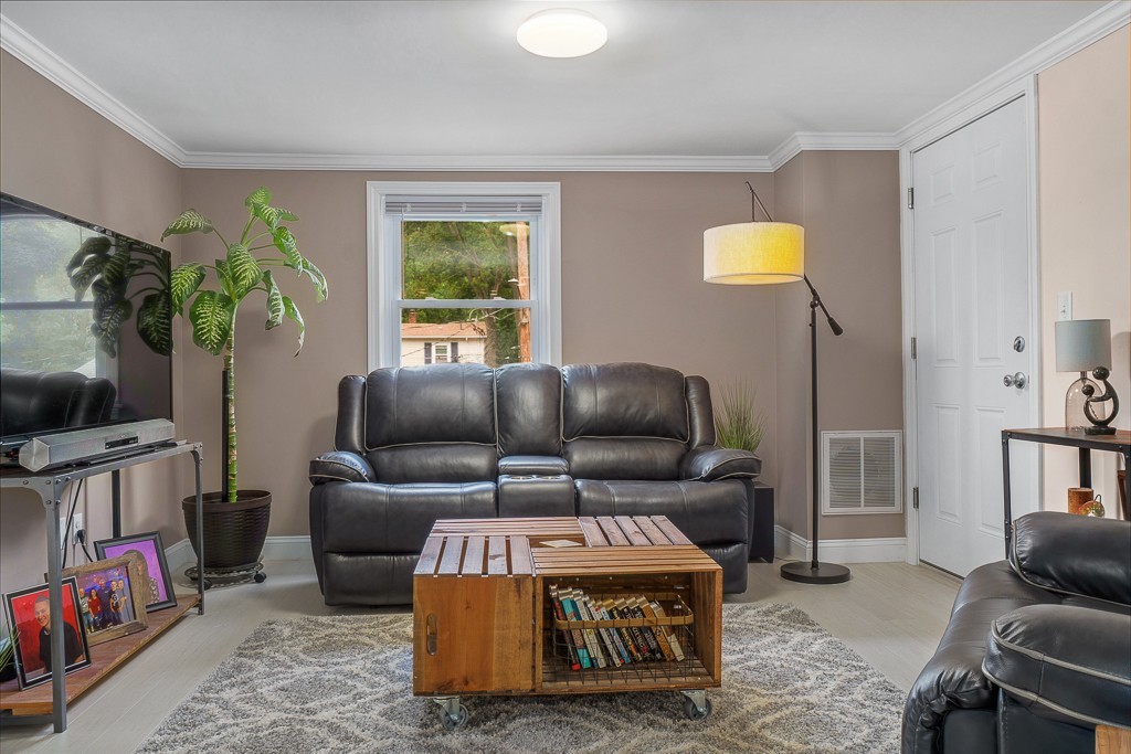 10 Riverbank Road, Unit 3 Maynard, MA 01754 - Photo 3 of 20 a living room with furniture and a flat screen tv