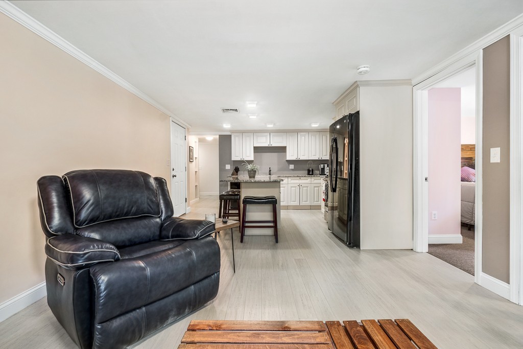 10 Riverbank Road, Unit 3 Maynard, MA 01754 - Photo 5 of 20 a living room with stainless steel appliances furniture and a kitchen view