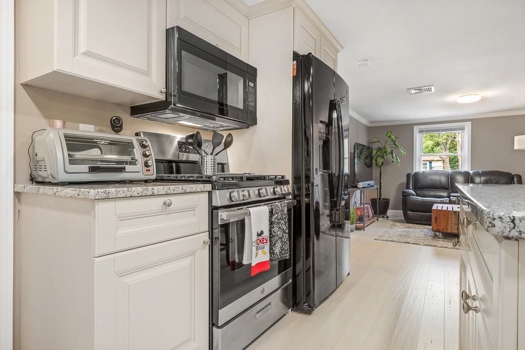 10 Riverbank Road, Unit 3 Maynard, MA 01754 - Photo 7 of 20 a kitchen with stainless steel appliances granite countertop a stove and a sink