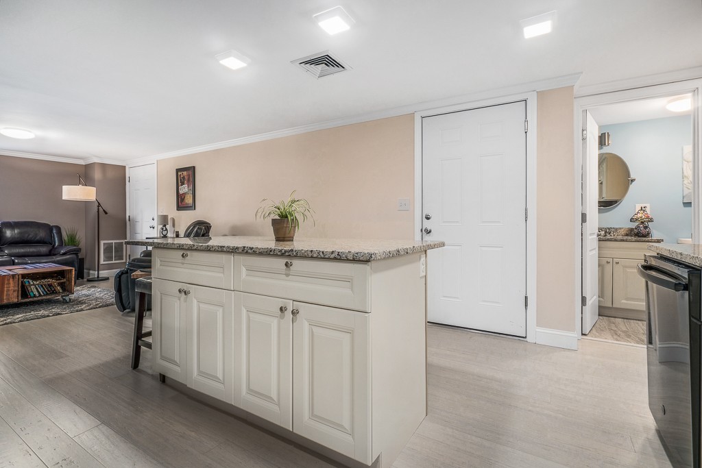 10 Riverbank Road, Unit 3 Maynard, MA 01754 - Photo 9 of 20 a kitchen with cabinets and chairs