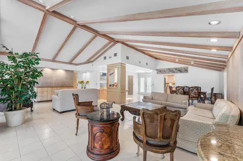 a living room with furniture and flowers