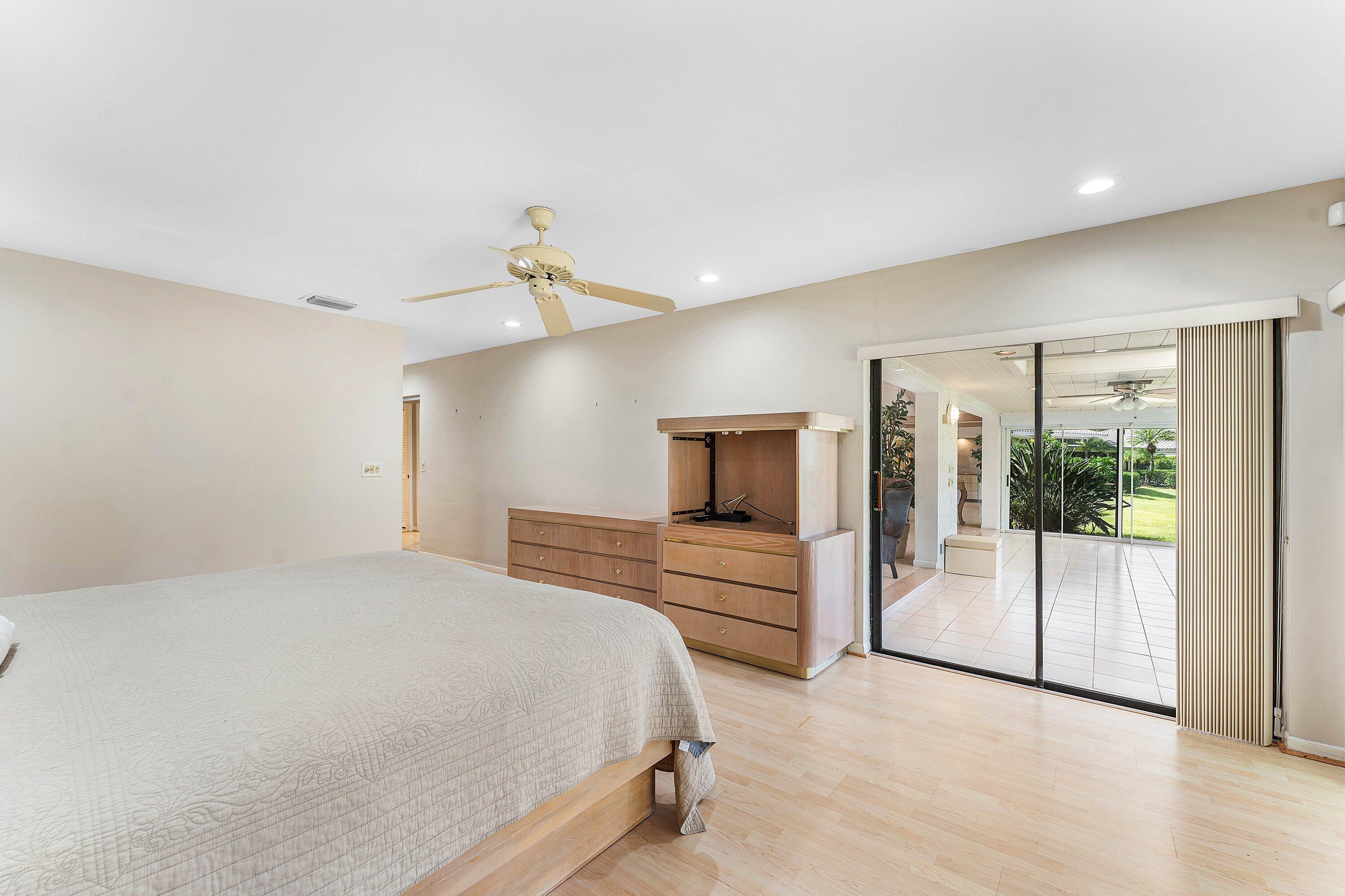 30 Hampshire Lane Boynton Beach, FL 33436 - Photo 39 of 84 a bedroom with a large bed and a view of bathroom