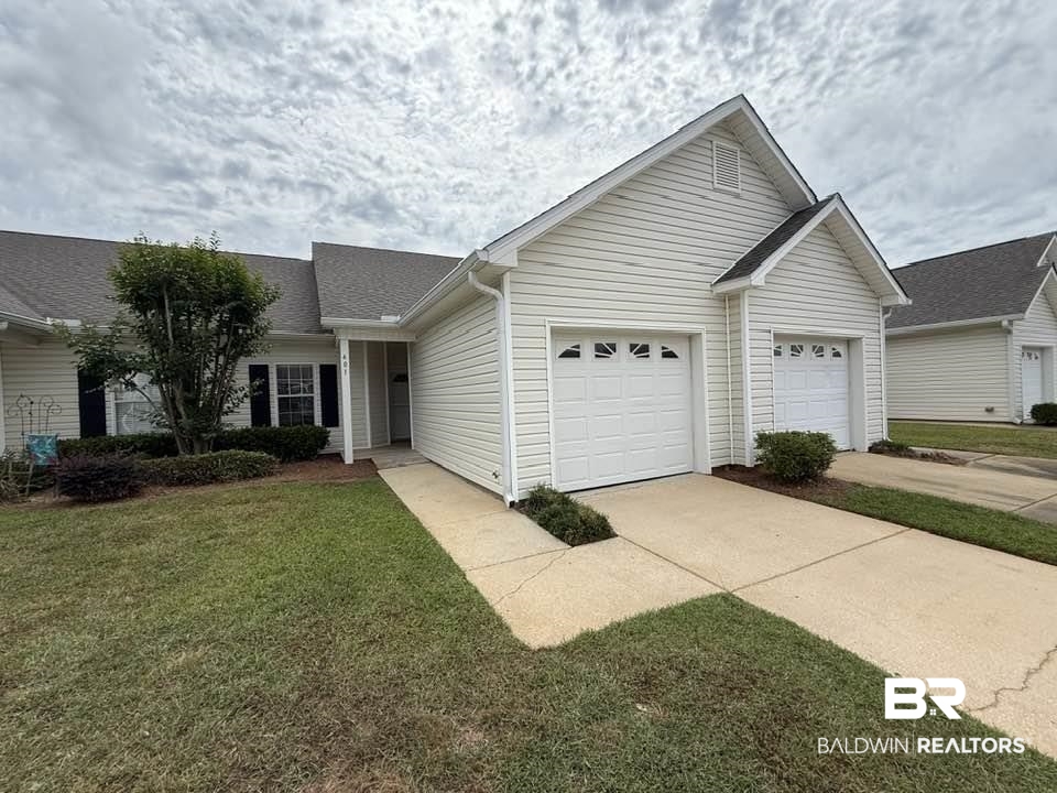 2651 South Juniper Street, Unit 401 Foley, AL 36535 - Photo 1 of 27 Ranch-style home with a front yard, concrete driveway, an attached garage, and a shingled roof