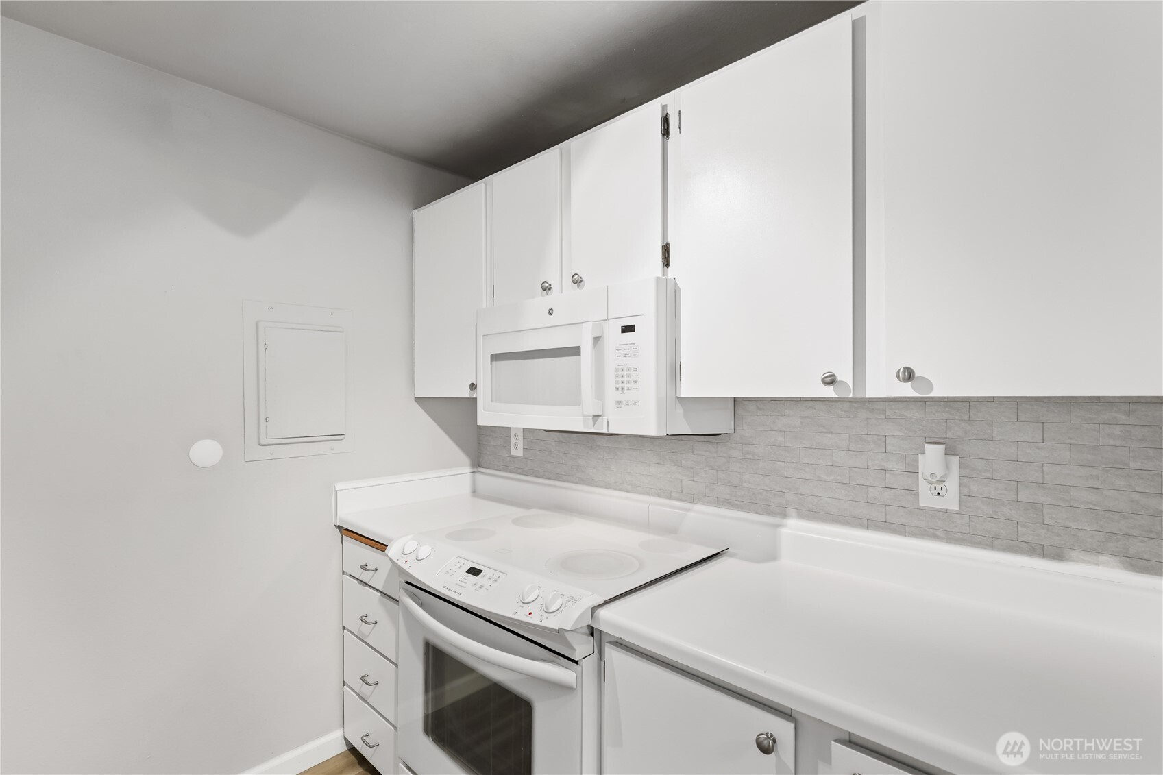 17536 149th Avenue Southeast, Unit O10 Renton, WA 98058 - Photo 6 of 31 a view of a kitchen with white cabinets