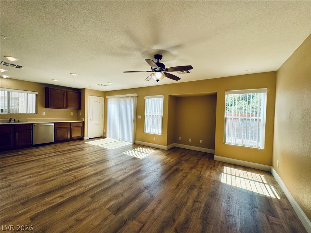 8617 Palomino Ranch Street Las Vegas, NV 89131 - Photo 7 of 27 Sun-filled open-concept living space with sleek flooring and kitchen access.