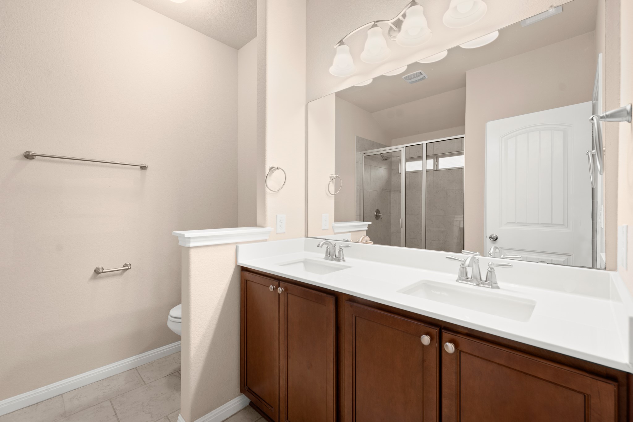 305 Longhorn Cavern Road Leander, TX 78641 - Photo 11 of 21 Get ready in style with this double vanity and huge mirror in the primary bath—no more fighting for sink space in the morning!