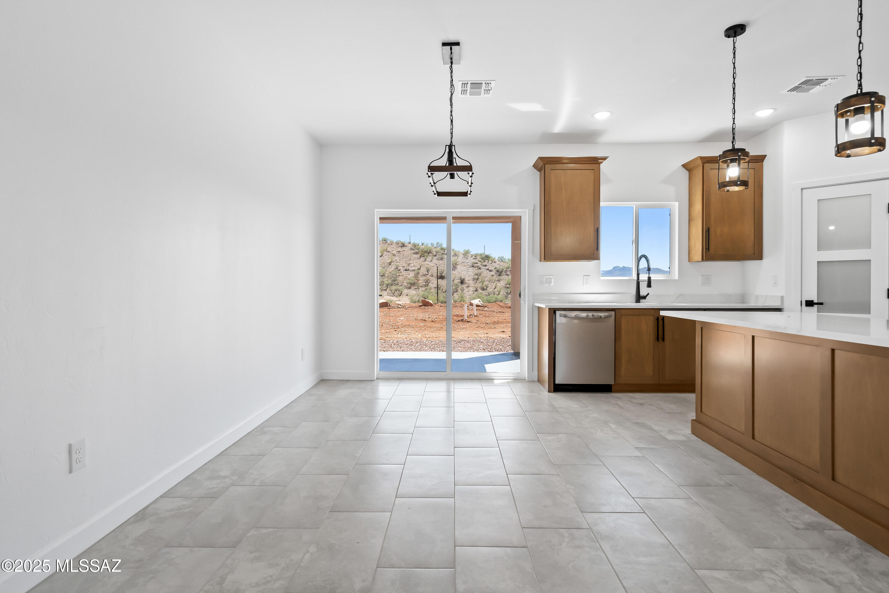 1667 Ave Calamar Rio Rico, AZ 85648 - Photo 15 of 33 a kitchen with a sink a counter top space appliances and cabinets