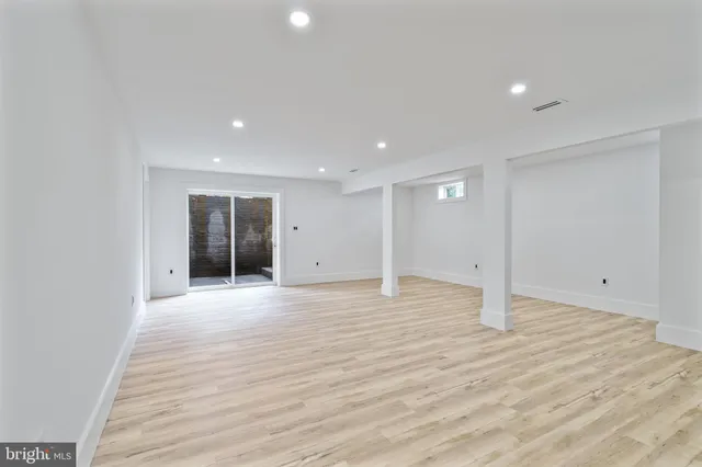 a view of a room with wooden floor