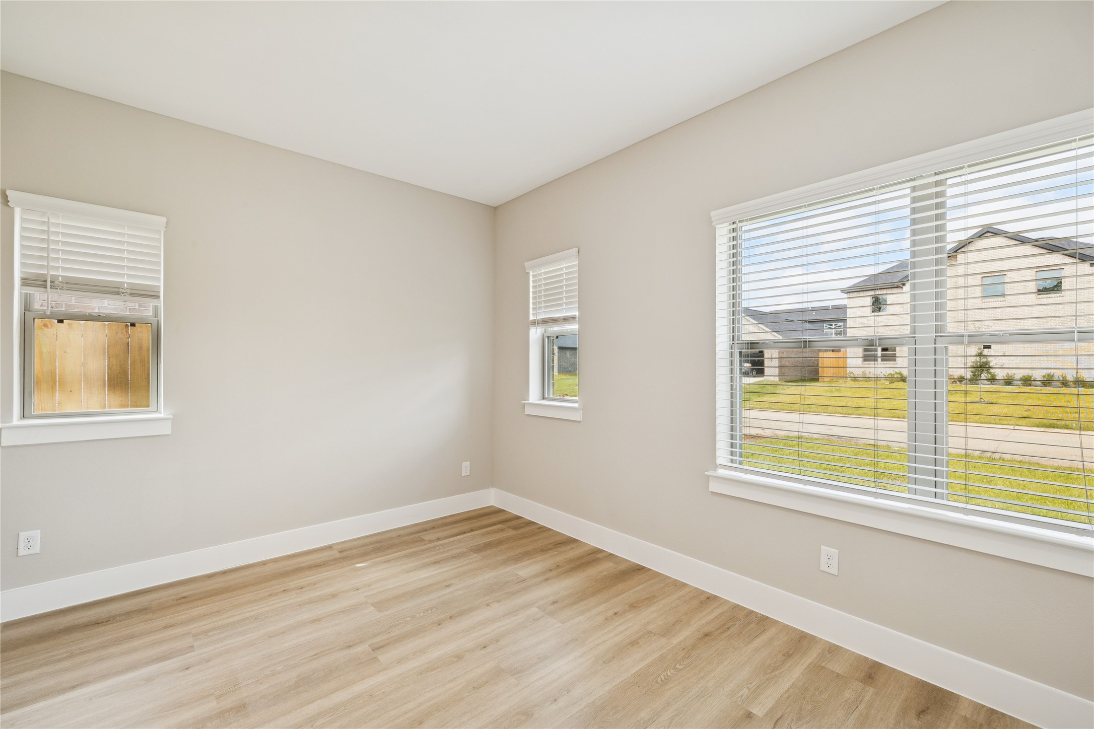 2610 Martinas Court Spring, TX 77388 - Photo 21 of 35 Bright, airy room with neutral walls, light wood flooring, and ample natural light from two windows with blinds. Ideal for a bedroom or home office.