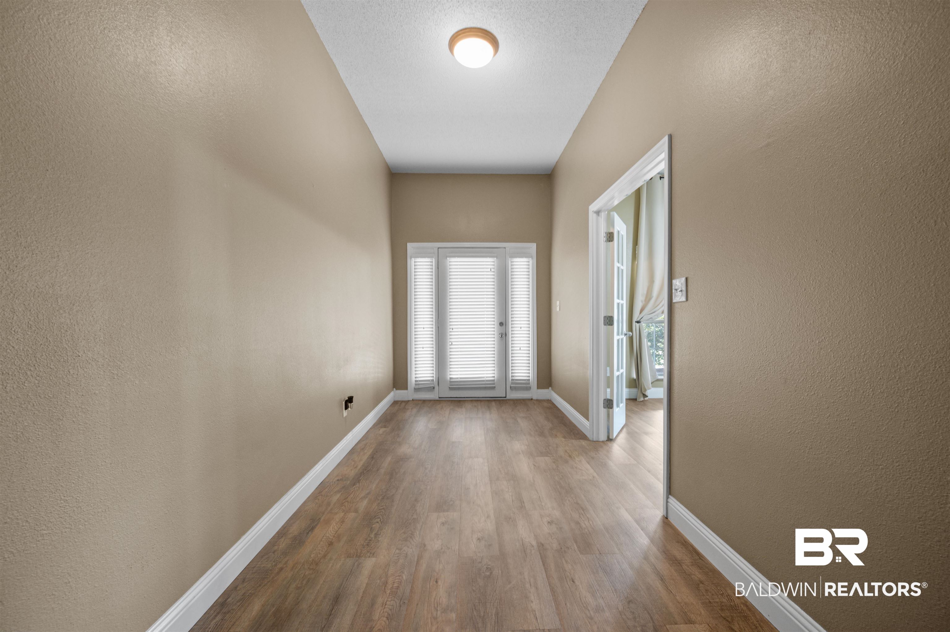 11705 Venice Boulevard Foley, AL 36535 - Photo 5 of 43 Doorway to outside featuring hardwood / wood-style flooring