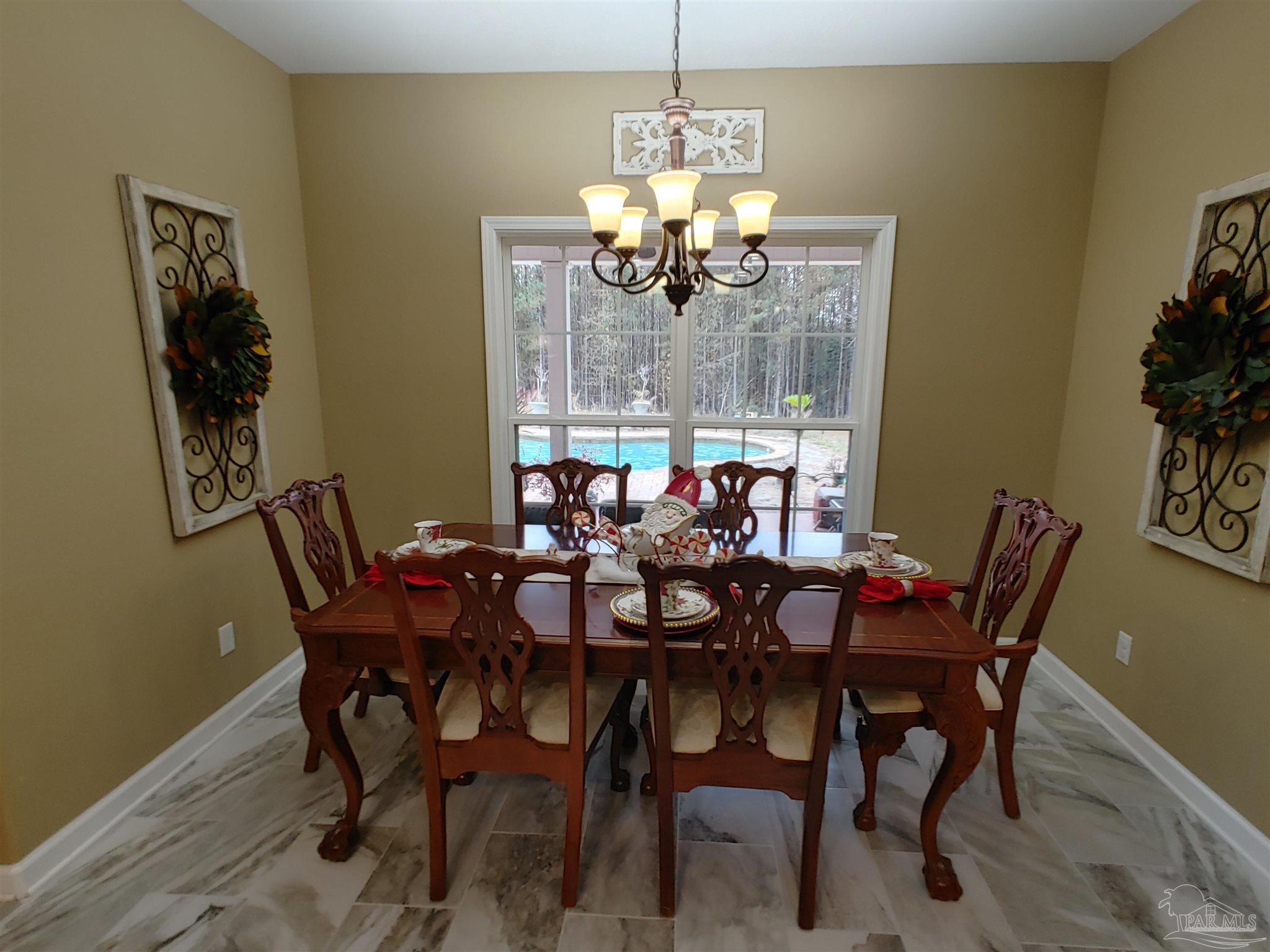 415 Clark Road Gilbertown, AL 36908 - Photo 17 of 50 a view of a dining room with furniture wooden floor and chandelier