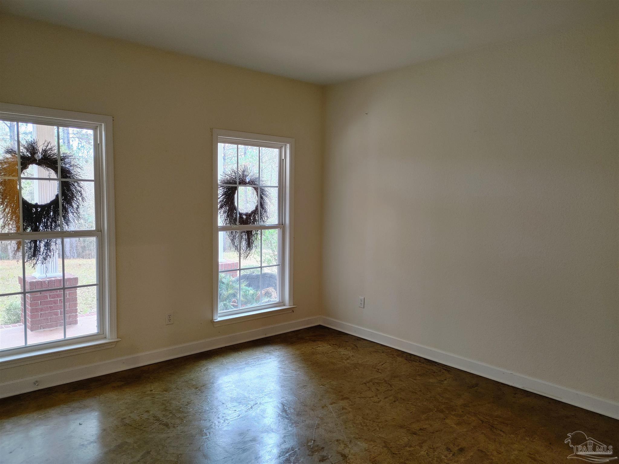 415 Clark Road Gilbertown, AL 36908 - Photo 26 of 50 an empty room with wooden floor and windows