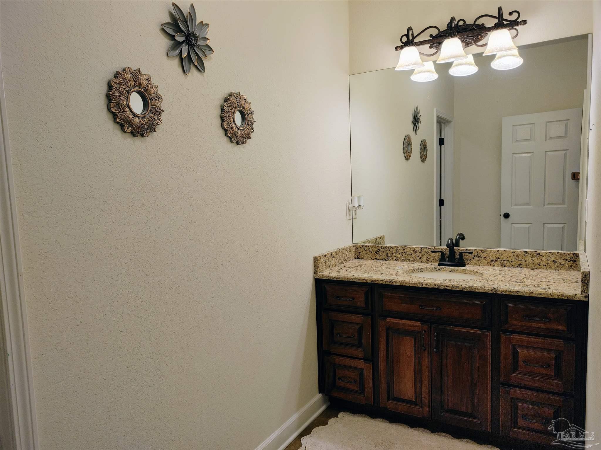 415 Clark Road Gilbertown, AL 36908 - Photo 27 of 50 a bathroom with a granite countertop sink and a mirror